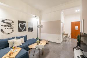 a living room with a blue couch and a table at Ports Crossroad C in Piraeus