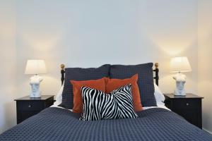 a bed with two lamps and a zebra pillow at Apt 1, 15 West Street in Hereford