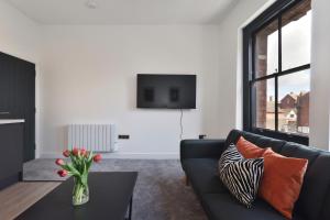 a living room with a couch and a table at Apt 1, 15 West Street in Hereford