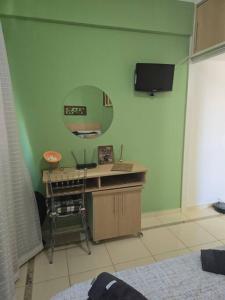 A television and/or entertainment centre at Hospedagem Flat verde Sul de Minas