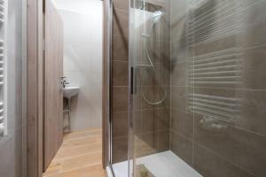 a shower with a glass door in a bathroom at New flat, Jachymov (Klinovec resort) in Karlovy Vary +11 photos
