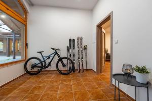 a room with a bike and skis leaned against a wall at New flat, Jachymov (Klinovec resort) in Karlovy Vary