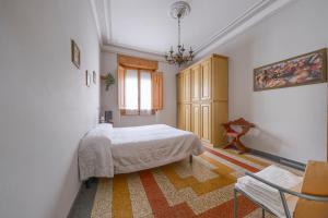 a bedroom with a bed and a table and a chair at Da Leonardo Apartment in Florence