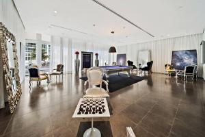 a living room with a pool table and chairs at Stunning Brickell Luxury Condo in Miami