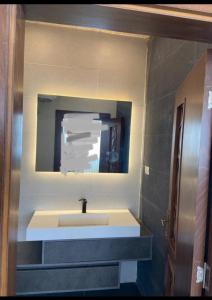 a bathroom with a sink and a mirror at 1BR-Deir Gbar rooftop in Amman
