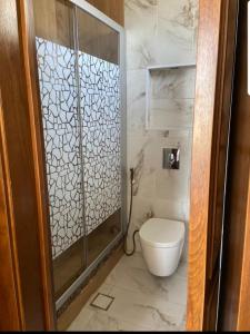 a bathroom with a shower and a toilet in it at 1BR-Deir Gbar rooftop in Amman