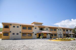 伊塔蒙蒂Hotel Águas Lindas的一栋带有鹅卵石庭院的大型公寓楼