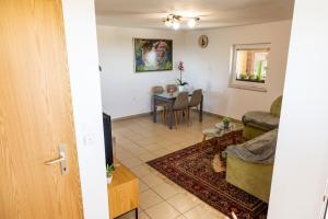 a living room with a couch and a table at APARTMA ENI in Moravske-Toplice
