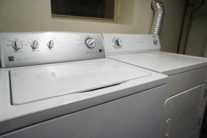 a white washer and dryer in a room at Cozy Nest in Chicago's Vibrant Lincoln Square in Chicago