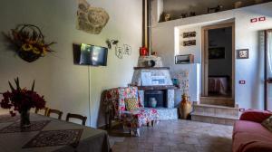 a living room with a table and a fireplace at Villa Romeo - Alloggio Pastore - Private Pool in Santa Caterina dello Ionio