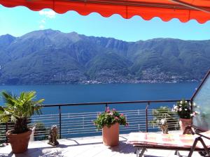 a balcony with a view of a lake and mountains at Casa Roccia in Pino Lago Maggiore