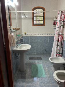 a bathroom with a sink and a toilet at Cozy & Relaxing Resort Oasis ~ Sports Field ~ Pool in Luque
