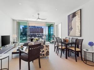a living room with a dining table and chairs at Gorgeous 2BR in Wynyard Quarter by Zodiak Stays in Auckland