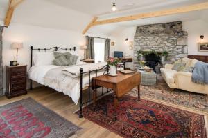 a bedroom with a bed and a living room at Pigeon Loft in Kirk Yetholm