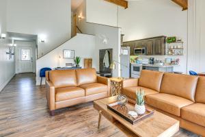 a living room with two couches and a table at Cozy Mtn Condo with Grill, 28 Mi to Wolf Creek! in Pagosa Springs
