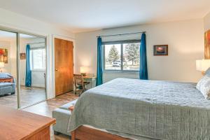 a bedroom with a bed and a window and a table at Cozy Mtn Condo with Grill, 28 Mi to Wolf Creek! in Pagosa Springs