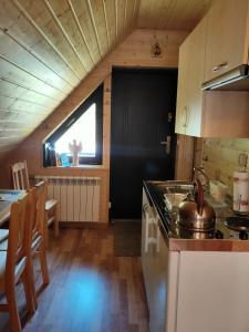 a kitchen in a tiny house with a large window at W Cisnej pod 1. in Cisna