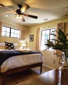a bedroom with a bed and a ceiling fan at Treehouse Cottage in Crestline