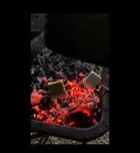 a bunch of food cooking on a fire at Adrasan Yıldız Bungalow Tatil Köyü in Adrasan