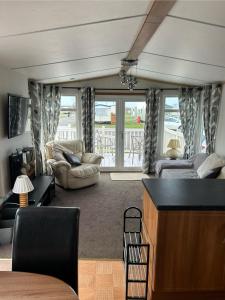 a living room with a couch and a table at 6 berth Ingoldmells The Grange With Ramp in Ingoldmells