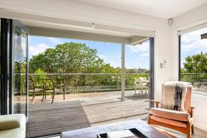 a living room with a large sliding glass door at Stylish and serene living in Kohimarama in Auckland