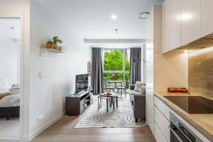 a kitchen and living room with a bed and a table at At the cultural heart of Auckland CBD in Auckland
