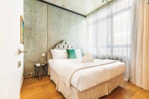 um quarto com uma cama grande e uma janela grande em Luxury meets location - 2RB in Ponsonby em Auckland