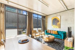uma sala de estar com um sofá e uma mesa em Luxury meets location - 2RB in Ponsonby em Auckland