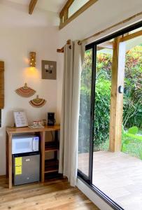 a room with a desk and a sliding glass door at Casa Yami Lodge in Fortuna