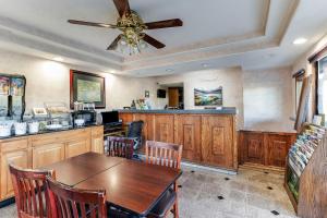 a kitchen with a table and a ceiling fan at Knights Inn Madera in Madera