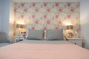 una camera da letto con un letto e carta da parati floreale di VIGO CENTRO a Vigo