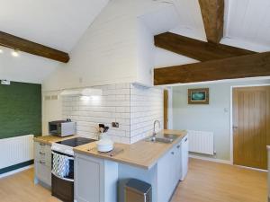 a kitchen with a sink and a counter top at Rosina Barn in Boddicott