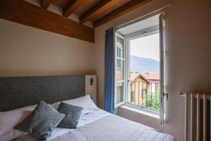 Кровать или кровати в номере Albergo Del Sole