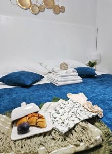 a tray with bread and other foods on a bed at Apartments Miljas 2 in Dubrovnik