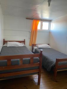 Postel nebo postele na pokoji v ubytování HOSTAL VALDIVIA