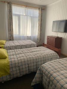 Postel nebo postele na pokoji v ubytování HOSTAL VALDIVIA