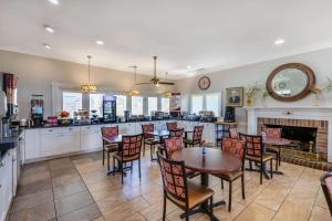 a restaurant with tables and chairs and a fireplace at Best Western PLUS Santee Inn in Santee