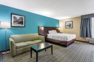 a hotel room with a bed and a couch at Best Western Plus Knoxville Cedar Bluff in Knoxville