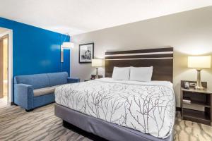 a hotel room with a bed and a blue chair at Best Western Plus Knoxville Cedar Bluff in Knoxville