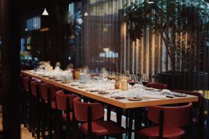 a long long table with chairs and glasses on it at Radisson Blu Scandinavia Hotel, Göteborg in Gothenburg