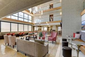 a lobby of a hotel with tables and chairs at Drury Inn & Suites Marion in Marion