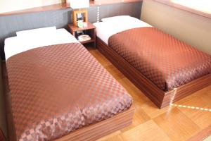 Postel nebo postele na pokoji v ubytování Hotel Saika