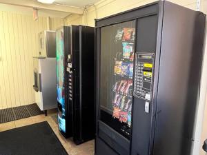 two refrigerators are next to each other in a room at Arbor Inn - Weymouth in Weymouth