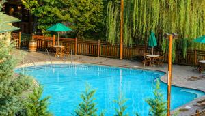 a swimming pool with umbrellas and tables and chairs at King Size bed Room with Hot tub in Gatlinburg