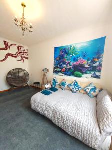 a bedroom with a large fish painting on the wall at The Octopus - at Largs Town Centre with Private Parking in Largs