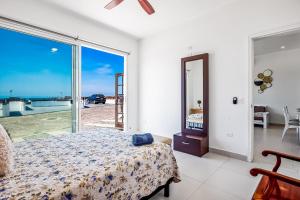 a bedroom with a bed and a view of the ocean at Casa Capri 39 - Playa Arcangel in Rosarito +32 photos