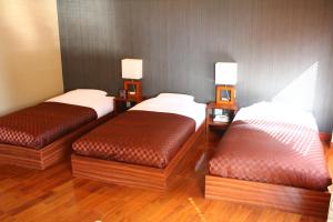 Postel nebo postele na pokoji v ubytování Hotel Saika
