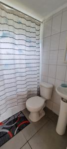 a bathroom with a toilet and a sink at Refugio Pucalan Lodge in Puchuncaví +11 photos