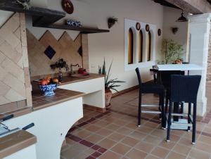 a kitchen with a counter and a table and chairs at Son Pujol in Las Ollerías