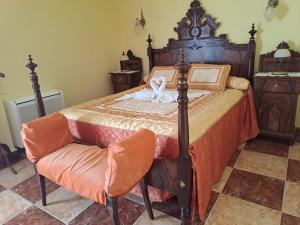 a bedroom with a wooden bed and a chair at Son Pujol in Las Ollerías